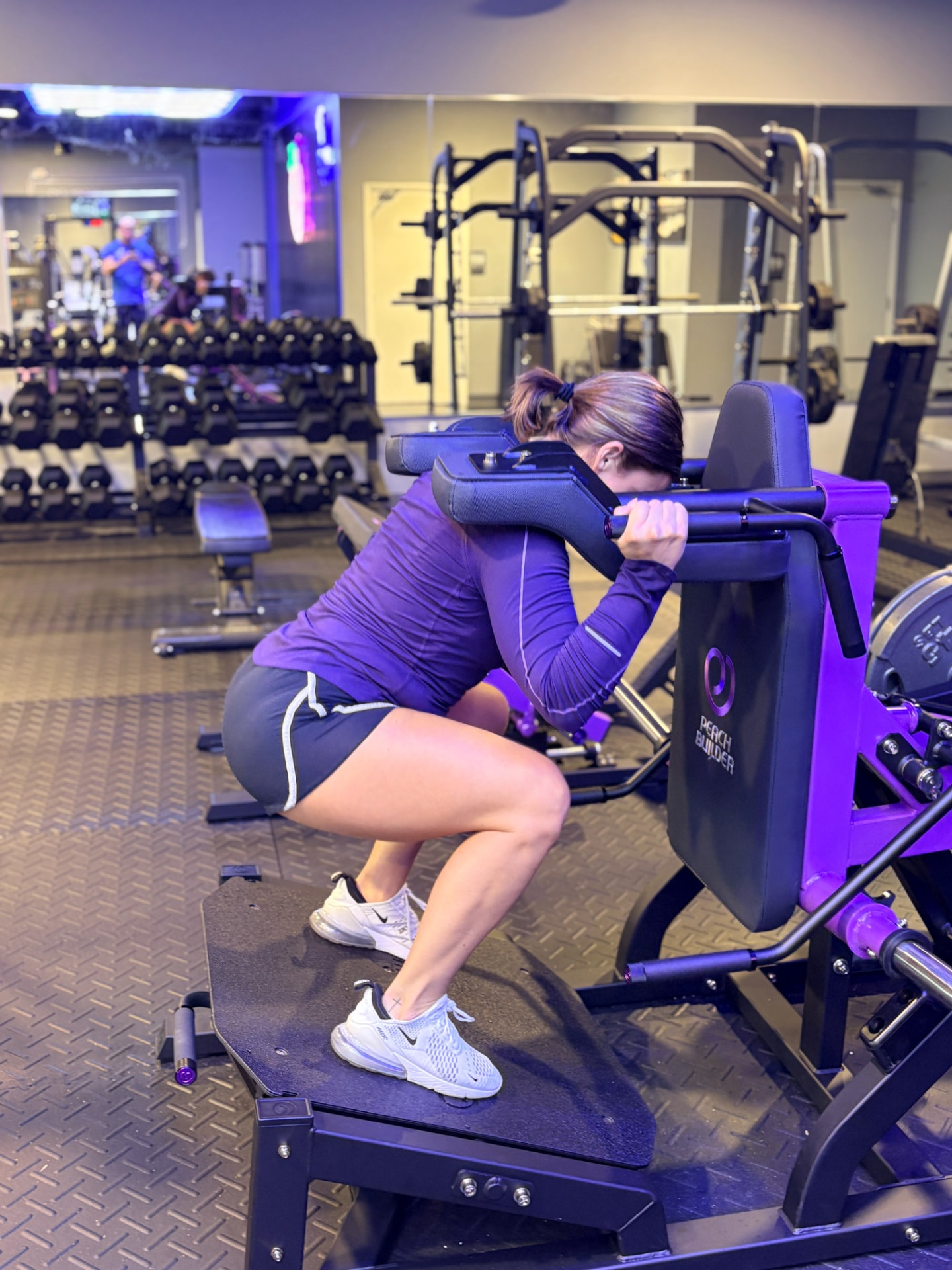 Member using the Peach Builder belt squat machine